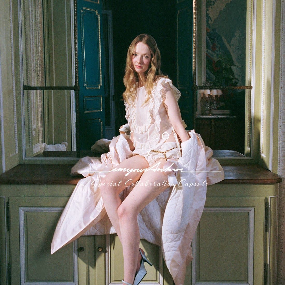 Seated beneath a chandelier