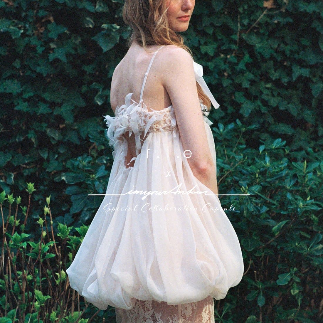 A bubble dress against ivy