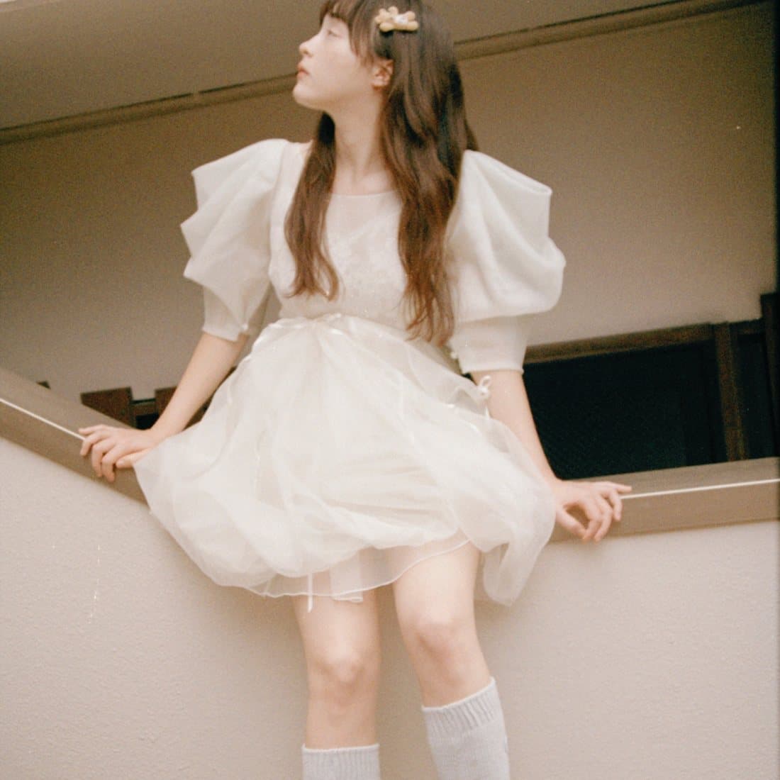 A white dress with arms raised